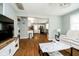 Open-concept living room showcasing hardwood floors and seamless flow into the kitchen at 4091 W Briarwood Lake S Dr, Monrovia, IN 46157