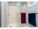 Modern bathroom featuring a glass-enclosed shower and grey tiled walls at 4091 W Briarwood Lake S Dr, Monrovia, IN 46157