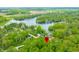 Scenic aerial view of a home nestled among lush greenery and a serene lake, marked with a location pin at 4291 E Lakeview Dr, Martinsville, IN 46151