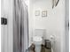 Modern bathroom featuring toilet, shower with curtain, and minimalist decor at 4291 E Lakeview Dr, Martinsville, IN 46151