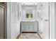 Bathroom with vanity, mirror, and modern lighting fixtures in a hallway at 4291 E Lakeview Dr, Martinsville, IN 46151