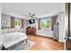 Bright bedroom boasts hardwood floors, a ceiling fan, and two windows offering ample natural light at 4291 E Lakeview Dr, Martinsville, IN 46151