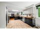 Well-lit kitchen with tile floors, butcher block countertops, stainless steel appliances, and ample cabinet space at 4291 E Lakeview Dr, Martinsville, IN 46151