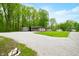 Brick home with a detached garage and a storage shed surrounded by a gravel driveway at 4291 E Lakeview Dr, Martinsville, IN 46151