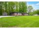 Spacious backyard featuring a brick home, green lawn, and additional storage shed at 4291 E Lakeview Dr, Martinsville, IN 46151