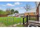 Lawn area with a view of the deck, fenced area, and parking area at 4730 Rookwood Ave, Indianapolis, IN 46208