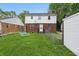 View of the backyard showing the rear of the home and patio seating at 4730 Rookwood Ave, Indianapolis, IN 46208