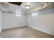 Basement features painted white walls and cement floor, and a window that brings in natural light at 4730 Rookwood Ave, Indianapolis, IN 46208