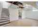 Spacious basement features stairs to the main floor, ample room, and white painted brick walls at 4730 Rookwood Ave, Indianapolis, IN 46208