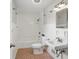Tiled bathroom with tub, toilet, sink, and simple mirror and lighting at 4730 Rookwood Ave, Indianapolis, IN 46208