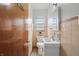 Small bathroom with single sink, peach tile, and medicine cabinet above the toilet at 4730 Rookwood Ave, Indianapolis, IN 46208