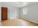 Bedroom with hardwood floors, window, and closet with paneled wood door at 4730 Rookwood Ave, Indianapolis, IN 46208