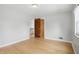 Bedroom with hardwood floors, window, and doorway to hallway and staircase at 4730 Rookwood Ave, Indianapolis, IN 46208