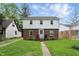 Charming two-story home featuring a brick and white facade with a well-maintained front yard at 4730 Rookwood Ave, Indianapolis, IN 46208