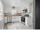 Bright kitchen features stainless appliances, gray floors, butcher block counters, and white cabinets at 4730 Rookwood Ave, Indianapolis, IN 46208