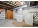 Basement laundry area features a washer and dryer hookup, wooden storage, and is freshly painted at 4730 Rookwood Ave, Indianapolis, IN 46208