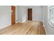Living room features hardwood floors and paneled doors plus a large window at 4730 Rookwood Ave, Indianapolis, IN 46208