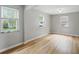 Living room with hardwood floors, multiple windows, and neutral walls at 4730 Rookwood Ave, Indianapolis, IN 46208