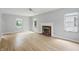 Spacious living room featuring hardwood floors, a fireplace, and bright natural light at 4730 Rookwood Ave, Indianapolis, IN 46208
