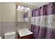 Cozy bathroom with a new toilet, classic sink, and patterned shower curtain with a new towel bar at 5027 E 40Th St, Indianapolis, IN 46226