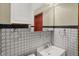 Bathroom featuring a stylishly tiled wall, vanity sink, and updated fixtures for a modern touch at 5027 E 40Th St, Indianapolis, IN 46226