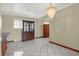 Bright dining room featuring tile floors, a decorative chandelier, and ample natural light from the large window at 5027 E 40Th St, Indianapolis, IN 46226