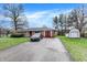 A well kept single story brick house features an attached garage, extra storage and a driveway at 5027 E 40Th St, Indianapolis, IN 46226