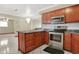 Well-equipped kitchen with stainless steel appliances, tile backsplash, island with drawers, and tile flooring at 5027 E 40Th St, Indianapolis, IN 46226