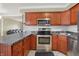 Bright kitchen with stainless steel oven, stainless steel sink and microwave, beautiful wood cabinets, and stone countertops at 5027 E 40Th St, Indianapolis, IN 46226