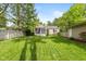 Large backyard with a screened porch, garage, and wood fence at 5526 Indianola Ave, Indianapolis, IN 46220