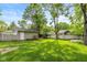 Spacious backyard featuring a lush lawn, garage, and a wood fence at 5526 Indianola Ave, Indianapolis, IN 46220