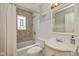 Cozy bathroom features a tub with mosaic tile surround and updated vanity at 5526 Indianola Ave, Indianapolis, IN 46220