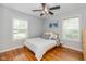 Bedroom with natural light, a ceiling fan, and hardwood floors that create a cozy atmosphere at 5526 Indianola Ave, Indianapolis, IN 46220