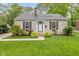 Charming single-story home featuring neutral paint, black shutters, manicured lawn, and tidy landscaping at 5526 Indianola Ave, Indianapolis, IN 46220