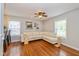 Bright living room with hardwood floors, large sectional sofa, and natural light from multiple windows at 5526 Indianola Ave, Indianapolis, IN 46220