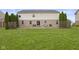 Wide backyard featuring a wood deck, large lawn, and perimeter landscaping at 5851 Grand Ave, Plainfield, IN 46168