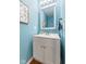 Chic powder room with a vanity, decorative mirror, and soothing blue walls at 5851 Grand Ave, Plainfield, IN 46168