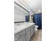 Bathroom with double sinks, gray cabinets, and a framed mirror, plus a shower behind a dark blue curtain at 5851 Grand Ave, Plainfield, IN 46168