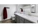 Bathroom features a double sink vanity with gray cabinets and a speckled countertop plus a standard toilet at 5851 Grand Ave, Plainfield, IN 46168