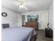 Bedroom with wood-look floors, ceiling fan, and an ensuite bath, plus decorative decor and natural light at 5851 Grand Ave, Plainfield, IN 46168