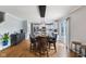 Open-concept dining area featuring hardwood floors and contemporary pendant lighting at 5851 Grand Ave, Plainfield, IN 46168