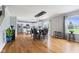 Dining area with hardwood floors, modern lighting, and a view of the adjacent white kitchen at 5851 Grand Ave, Plainfield, IN 46168