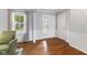 Bright foyer with hardwood floors, wainscoting, and a large window welcoming natural light at 5851 Grand Ave, Plainfield, IN 46168