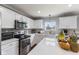 Bright, updated kitchen with white cabinets, stainless steel appliances and a view from the window at 5851 Grand Ave, Plainfield, IN 46168