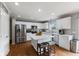 Bright kitchen with white cabinets, stainless steel appliances, and a center island with seating at 5851 Grand Ave, Plainfield, IN 46168