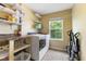 Laundry room with side-by-side washer and dryer and built in shelving plus a window for natural light at 5851 Grand Ave, Plainfield, IN 46168