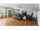 Cozy living room featuring hardwood floors, a ceiling fan, and a large window for natural light at 5851 Grand Ave, Plainfield, IN 46168