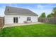 Spacious backyard with a well-maintained lawn, patio, and a privacy fence at 610 Redwood Dr, Pendleton, IN 46064