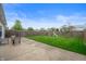 Large backyard featuring a patio area, lush grass, and a playset for outdoor enjoyment at 610 Redwood Dr, Pendleton, IN 46064