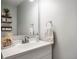 Modern bathroom vanity with a sleek countertop, chrome faucet, and decorative accents at 610 Redwood Dr, Pendleton, IN 46064